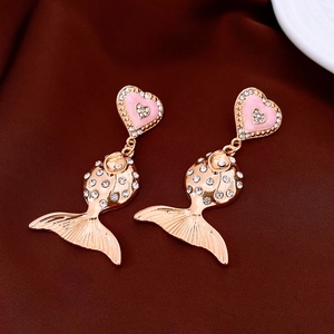 Detail of vintage goldfish drop earrings with pink hearts and sparkling rhinestones