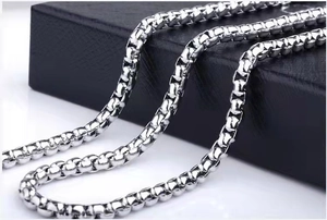 Macro view of polished silver square box chain necklace in stainless steel