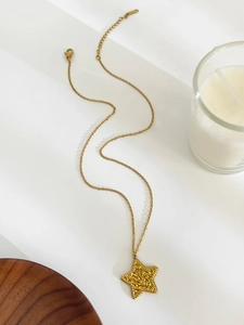Detail of gold star pendant with hammered texture and adjustable lobster clasp chain