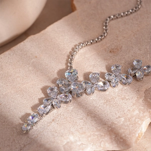 Macro shot of silver zircon flower earring with pear-cut gems on natural stone