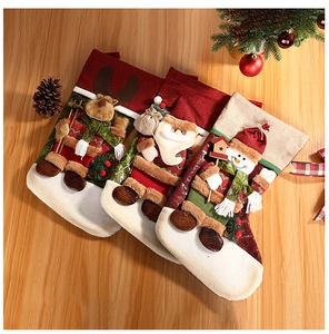 Detailed view of 3D reindeer, Santa, and snowman Christmas stockings on a wooden table