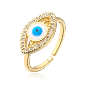 Macro side view of gold evil eye ring with blue zircon inlay and adjustable band
