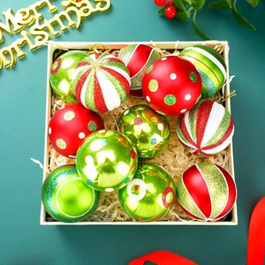 Green and red Christmas ball ornaments with stripes and glitter in a beige gift box
