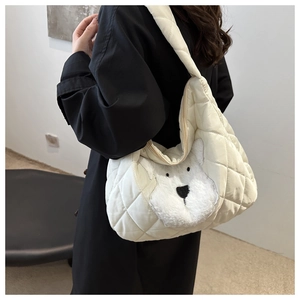 Close-up of white quilted tote bag featuring a 3D plush polar bear head and padded strap