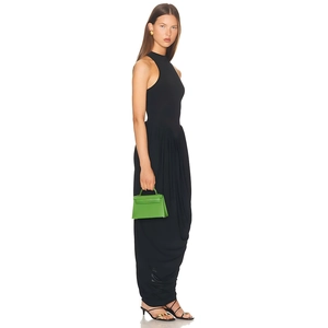 Side view of elegant black ruched sleeveless maxi dress with draped fabric details