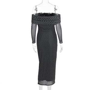 Detail of Bardot neckline and mesh polka dot sleeves on a black fitted dress