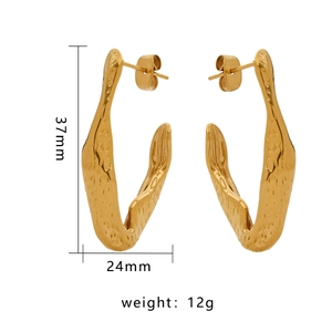 Detailed view of gold irregular hammered C-shaped earrings with 37mm height and 12g weight