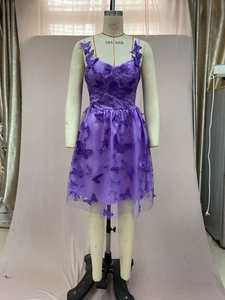 Detail of purple tulle dress with 3D butterfly appliques and intricate floral embroidery