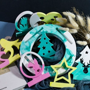 Detalle de adornos de resina colorida con formas de estrella y conejo en tela azul