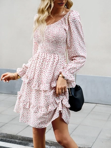 Detail of white floral dress featuring smocked elastic bodice and ruffled long sleeves