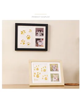 Detail of wooden pet paw print memorial frame with double photo slots and gold clay area