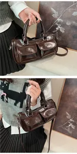 Detail of vintage dark brown glossy saddle bag featuring double front flap pockets