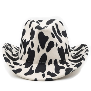 Detailed close-up of thickened cow print fabric and curved brim of the western cowboy hat