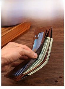 Detail of brown leather wallet interior with nylon lining and precise stitching