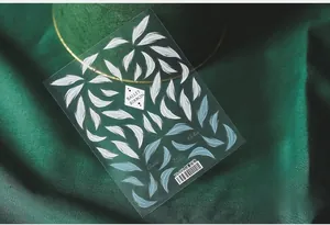 Detailed view of TS-099 5D white ballet ribbon nail art stickers on green silk fabric