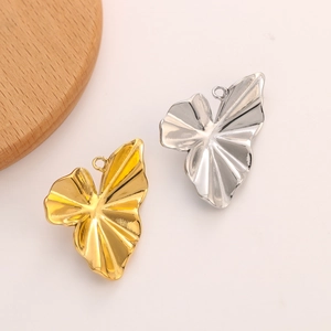 Close-up of vintage sunflower pendants in gold and silver finish for DIY jewelry