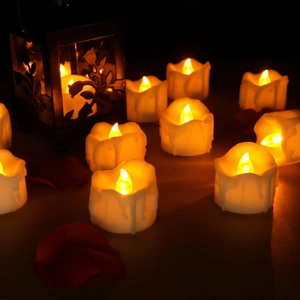 Close-up of LED electronic candles with warm yellow light and vintage lanterns