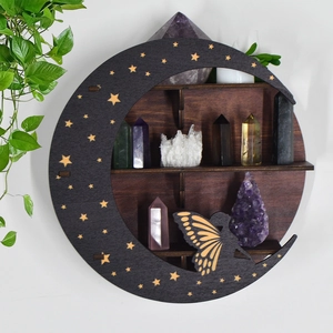 Macro shot of dark wooden moon shelf with fairy and star cutout for crystal display