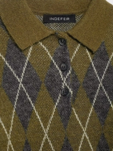 Detailed view of argyle knit polo shirt with soft fuzzy texture and classic three-button collar