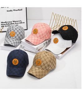 Detail view of jacquard baseball caps in six colors with metallic logo on leather patch