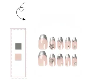 Detail of nude pink coffin nails with silver french tips and 3D star decorations
