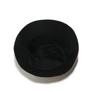 Detail view of the black inner lining and round crown structure of the sun bucket hat