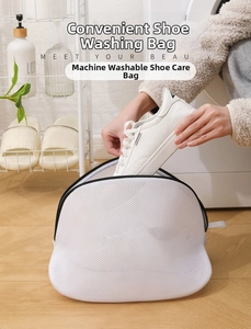 Detail of putting white sneakers into the fine mesh laundry bag for washing machine