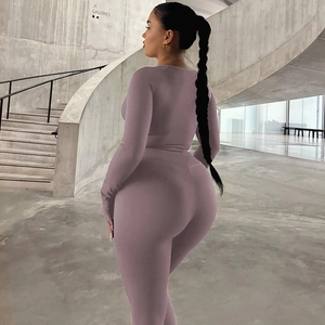 Detail of high-waisted yoga pants and slim-fit long sleeve top in mauve knit fabric