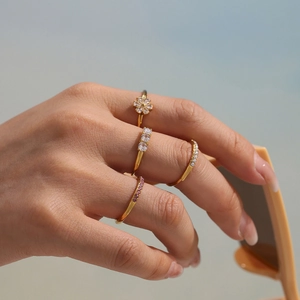 Set of four delicate gold stainless steel rings with 5A zircon flowers and pink stones