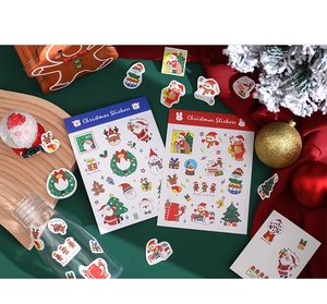 Flat lay of festive Christmas stickers with Santa, reindeer, and trees on red and green background