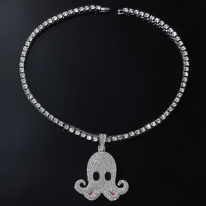 Macro shot of silver 5mm tennis chain with iced-out octopus pendant on black background