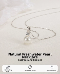 Macro detail of S925 sterling silver V-shape pendant with round natural pearl and zircons