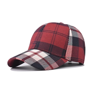 Detail view of red and black houndstooth baseball cap with six-panel design and curved brim