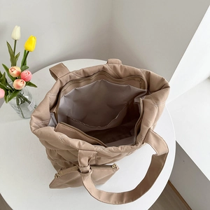 Quilted khaki nylon tote bag with matching coin purse shown from an overhead interior view