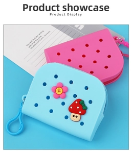 Close-up of silicone hole-style mini bags in pink and blue with cartoon charms