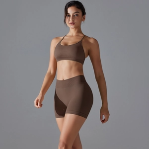 Detail of chocolate brown ribbed knit yoga set featuring high waist shorts and sports bra