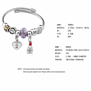 Detail showing colorful beaded bangle with heart lock and lipstick charm on a steel wire