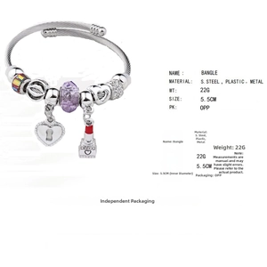 Detail showing colorful beaded bangle with heart lock and lipstick charm on a steel wire