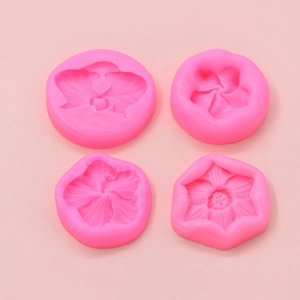 Set of 4 pink silicone flower molds for DIY baking and fondant in a 2x2 overhead view