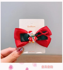 Details von Weihnachts-Haarspange mit kleiner Pinguin-Puppe und Glitzerschleifen