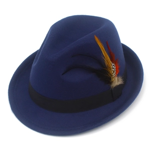 Detail view of navy blue wool felt fedora featuring a colorful feather and grosgrain ribbon
