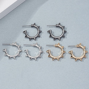 Punk style spiked hoop earrings set in gold, silver, and black finish for a bold fashion look