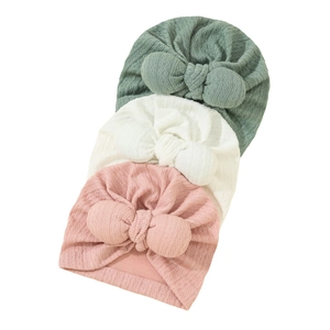 Textured knit baby turban hats with large bows in sage green, cream and pink