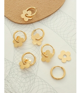 Macro shot of 18K gold plated flower charms and metal hoop earring component set