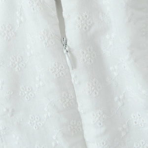 White halter dress featuring floral lace embroidery and a hidden back zipper closure