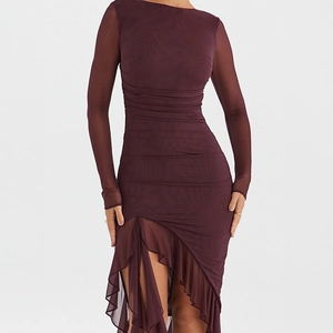 Close-up of elegant burgundy mesh dress with pleated texture and ruffle hem details
