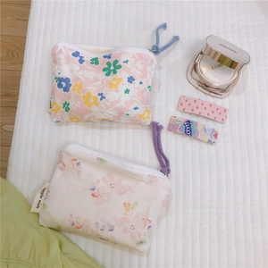 Floral mini cotton pouches for coins and cosmetics on a white quilted background