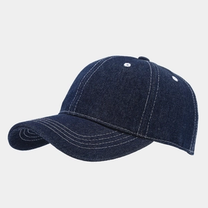 Close-up of navy denim baseball cap showing white contrast stitching and fabric texture