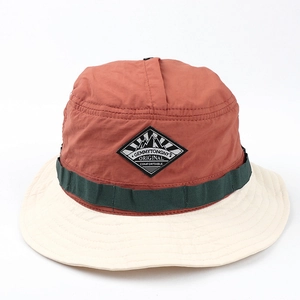 Detail of color-block outdoor bucket hat with embroidered logo patch and strap