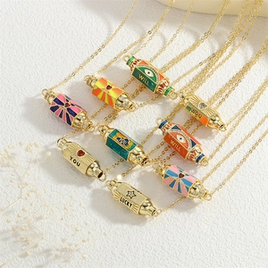 Detailed close-up of colorful enamel pendants on gold chains featuring Lucky and Heart motifs